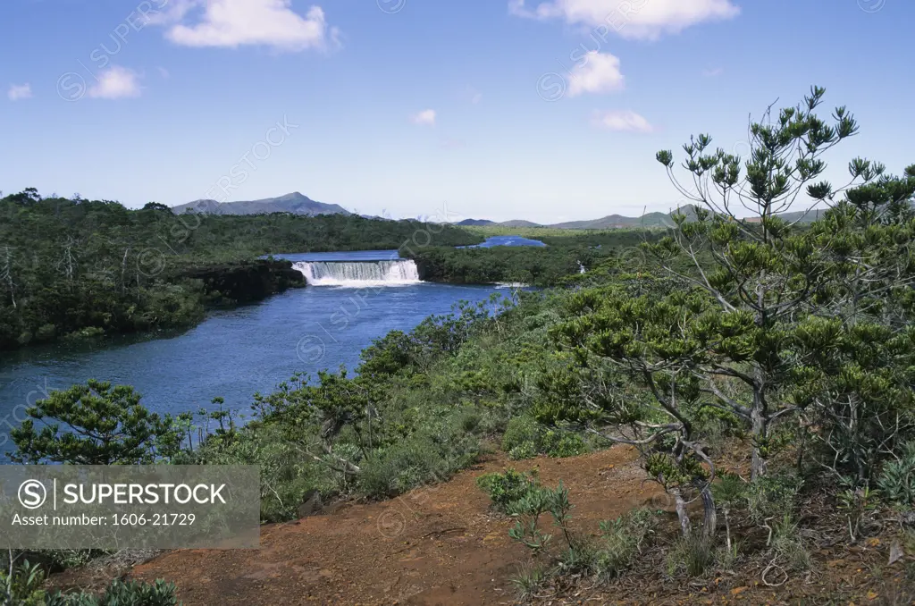 New Caledonia, Yate, La Madeleine waterfall, green landscape, blue sky, red earth