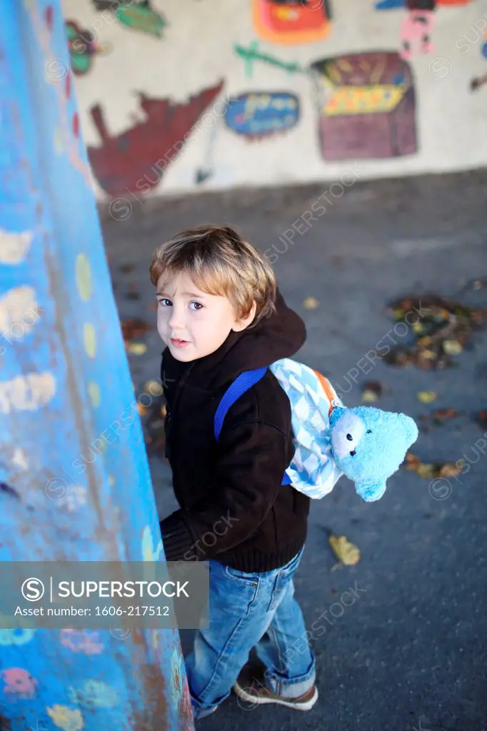 A little boy in a schoolyard