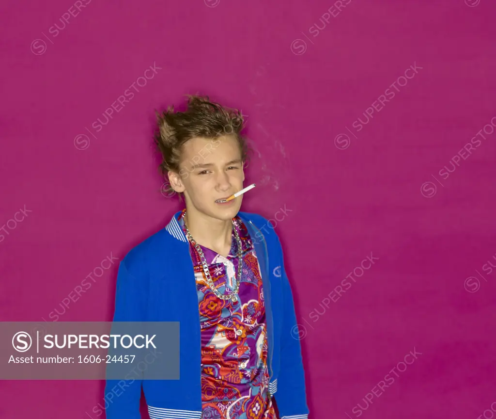 Teenage boy, blue gym jacket and colourful shirt, purple background, smoking a cigarette for the camera