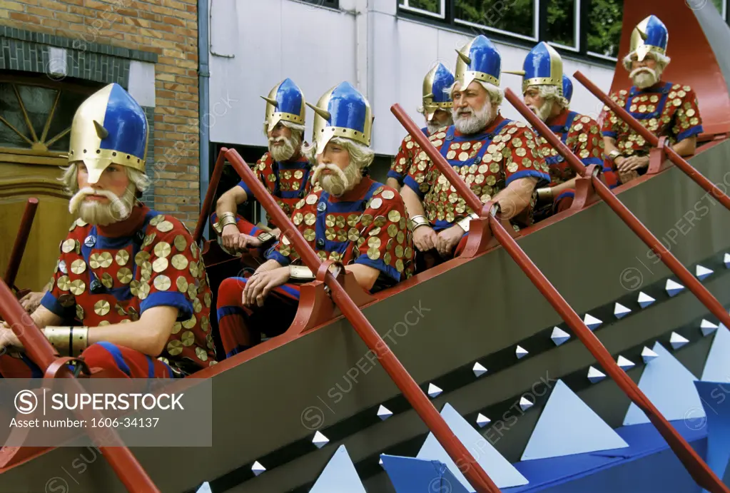 Belgium, Bruges, group of men disguised sitting on longship