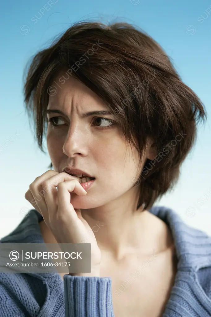Portrait girl biting her nails, worried