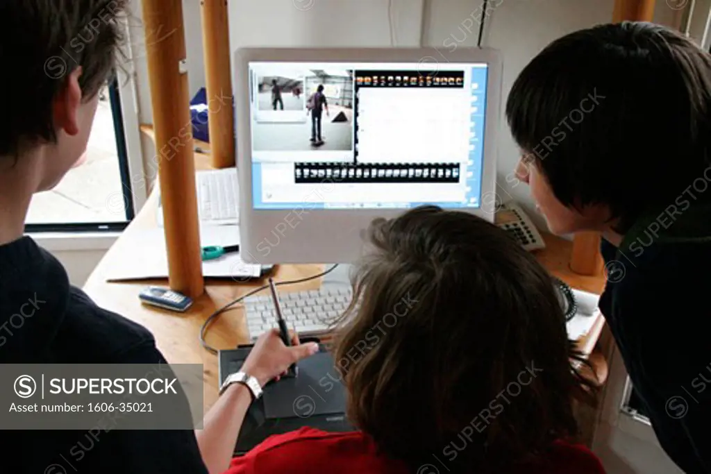 3 teenagers working, computer and graphic tablet