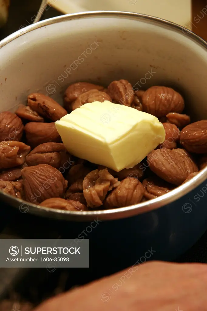 Close-up on chestnuts and butter in saucepan