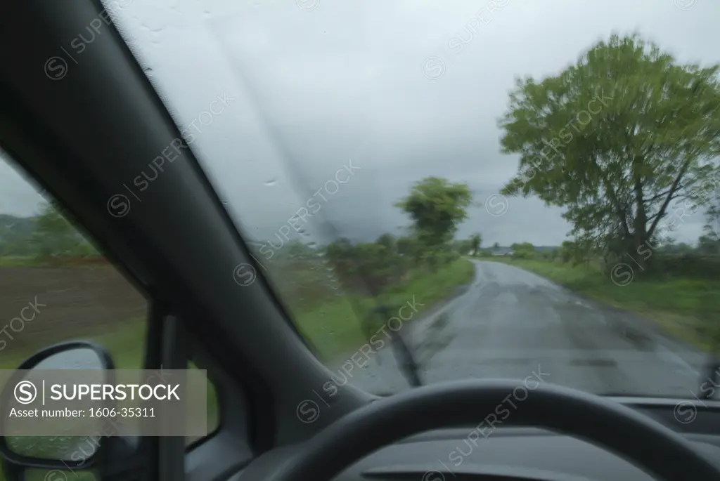 Wet road viewed through a car window