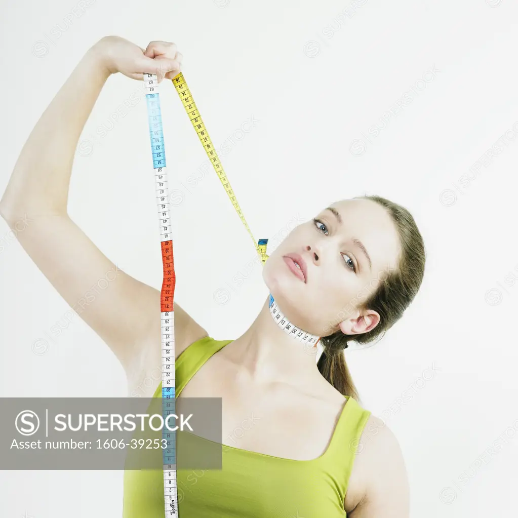 Portrait woman in green t-shirt, pulling tape measure around her neck