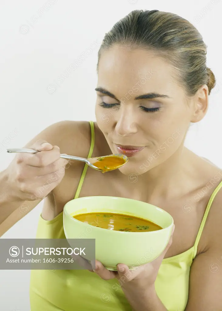 Portrait woman posing eating soup