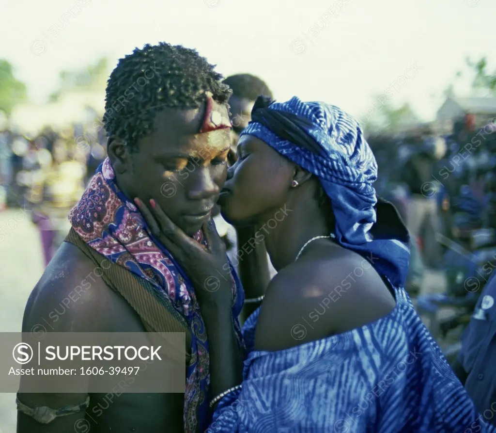 Senegal, woman kissing wrestler