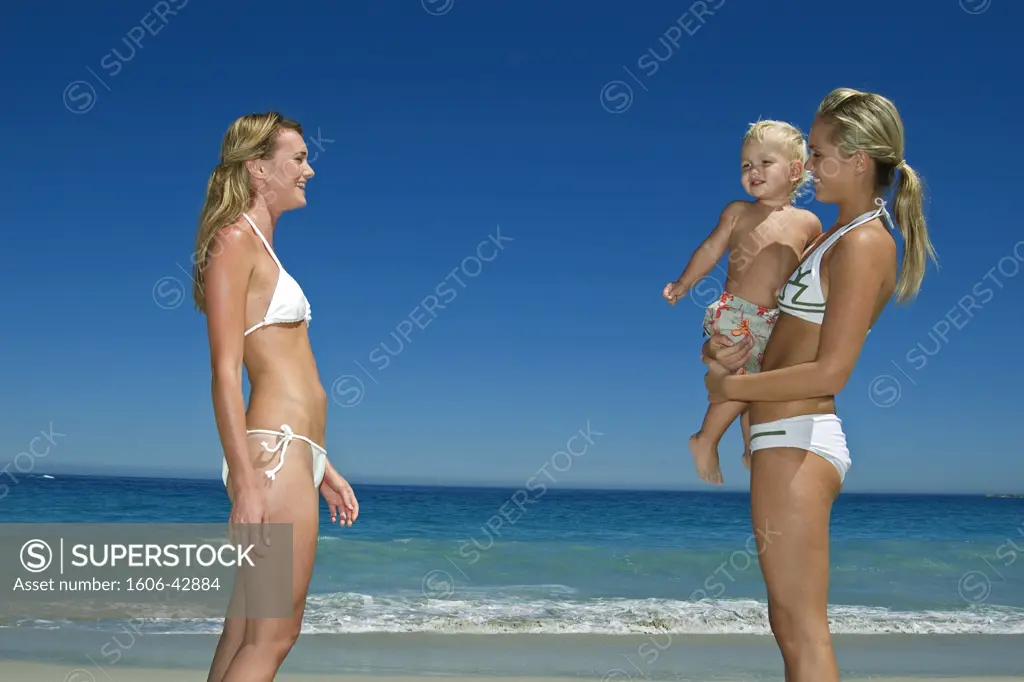 2 women and little boy on beach