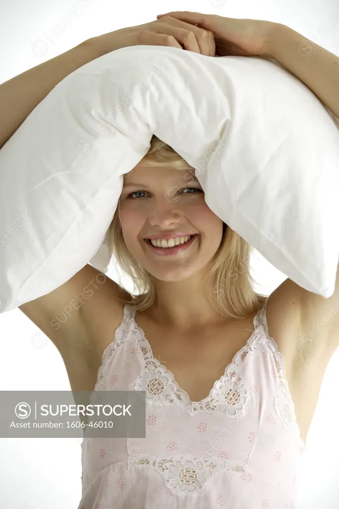 Portrait of a young woman with pillow on her head