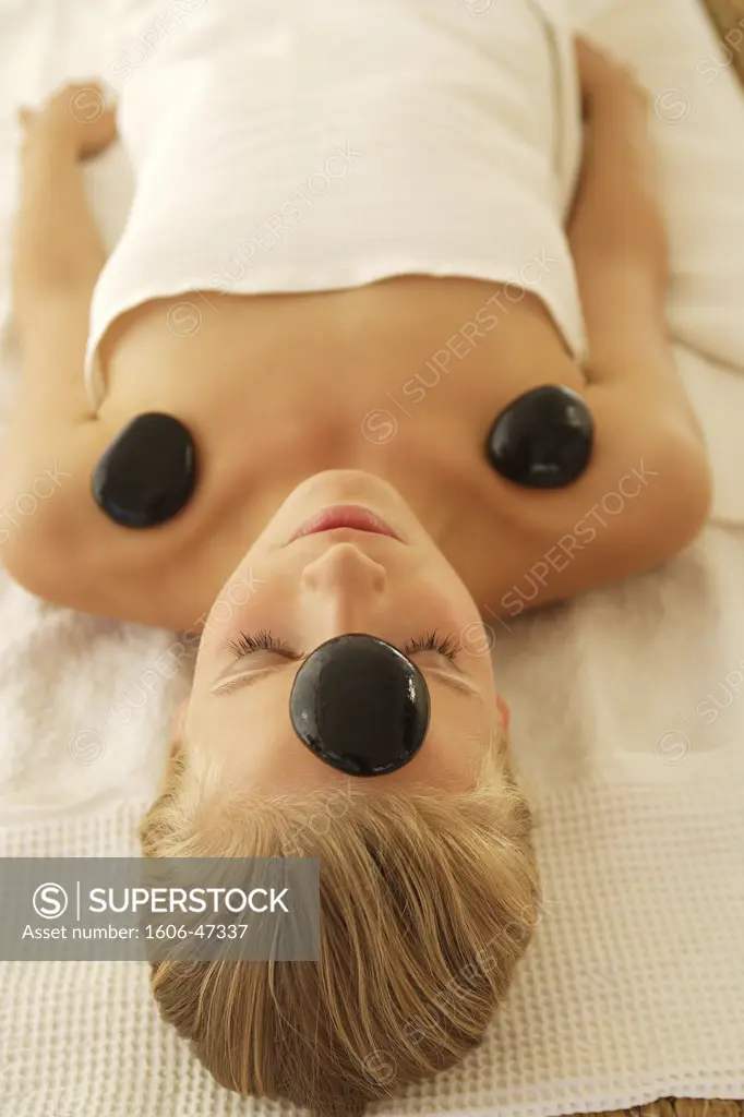 Christina lying on her back, stone massage