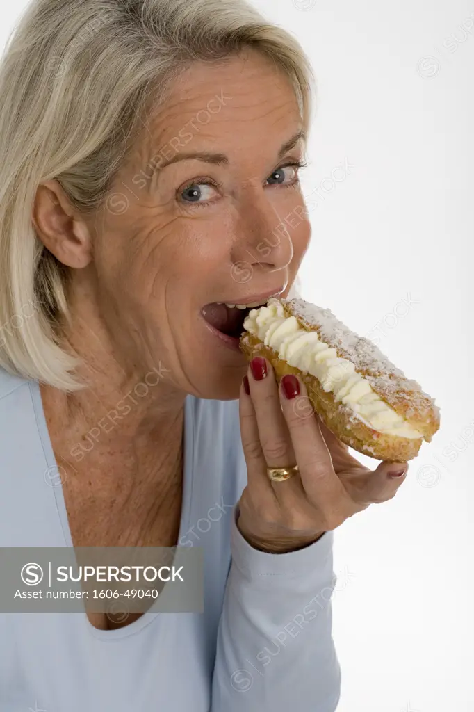 Mature woman eating a cake