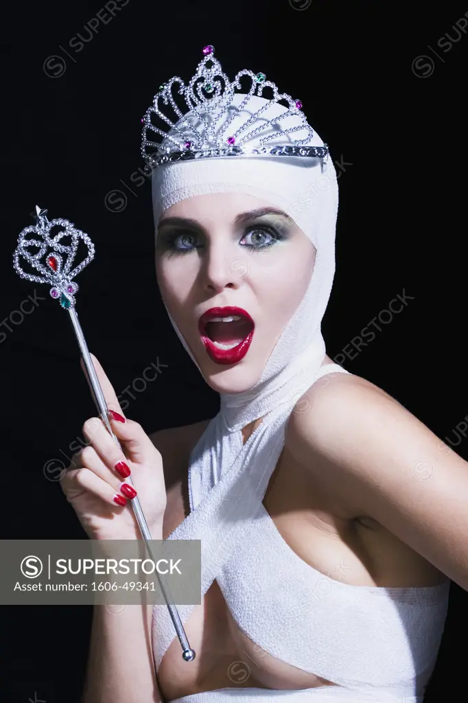 Young woman with bandages on head and breast, holding fairy wand, tiara