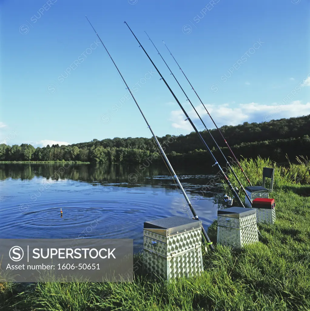 Fishing rods and fishing seat boxes by a lake