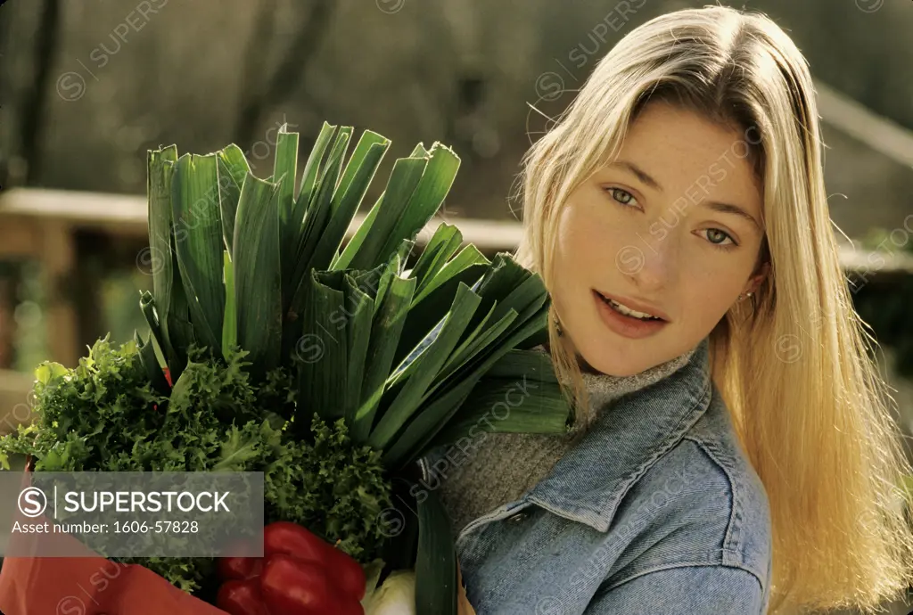 Young woman holding vegetables