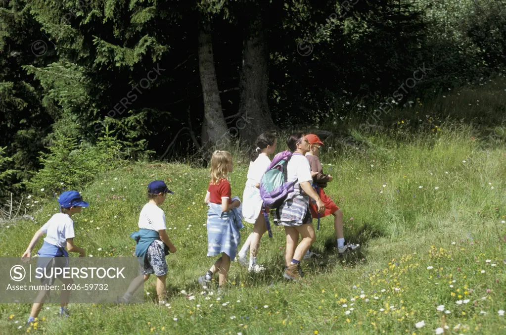 France, Rhone Alpes, Savoie, woman and children having a hike in moutain in summer