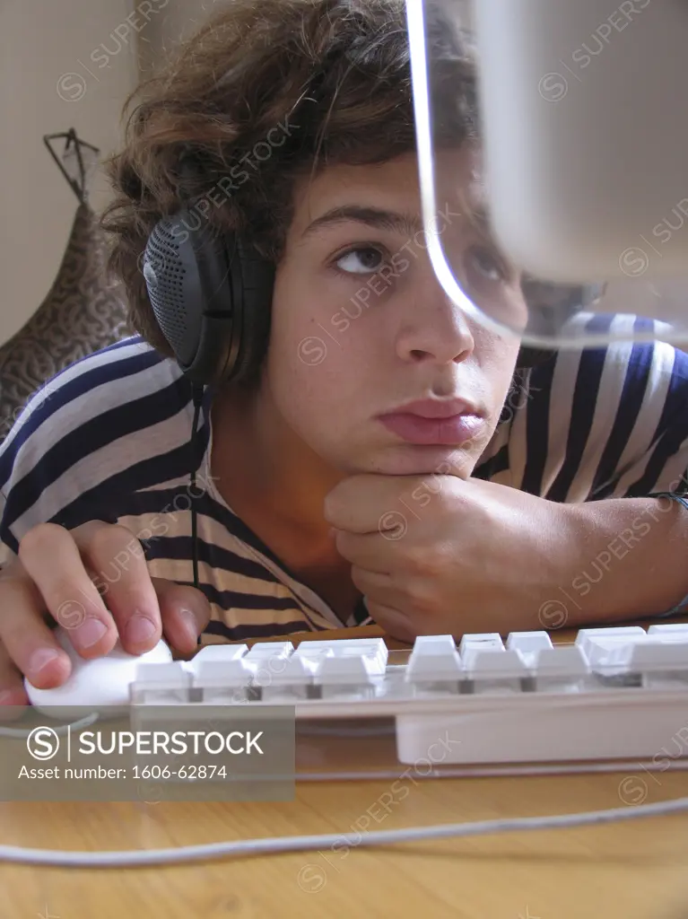 Boy with headphones in front of his computer