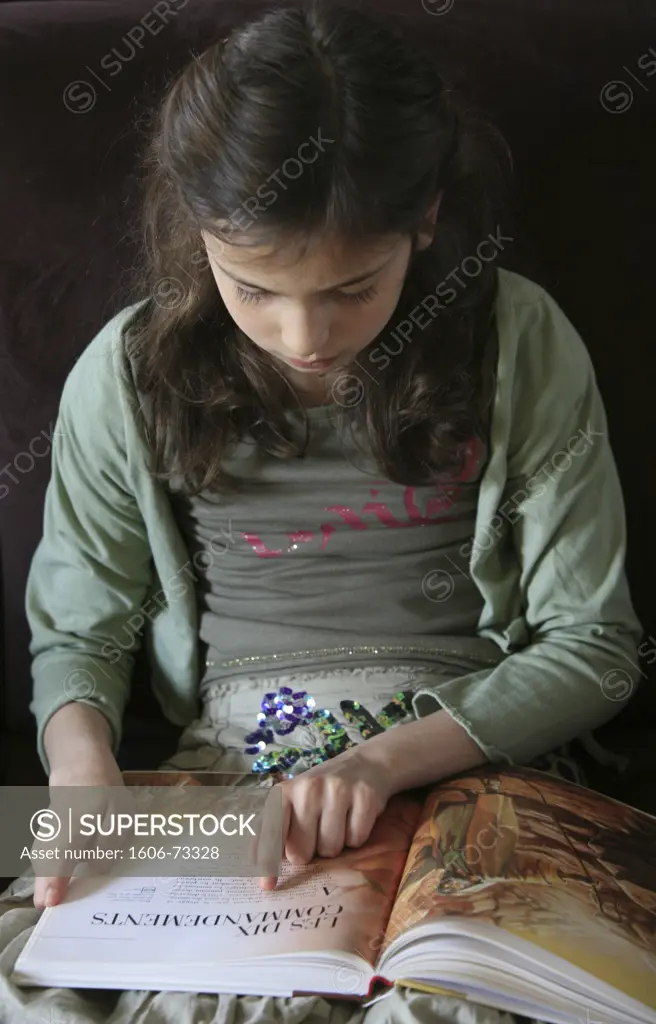 France, Hauts de Seine, Montrouge, Girl reading the Bible