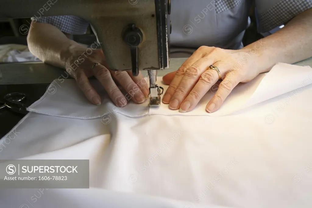 France, Rhones-Alpes, Irigny, Sewing a monk's frock