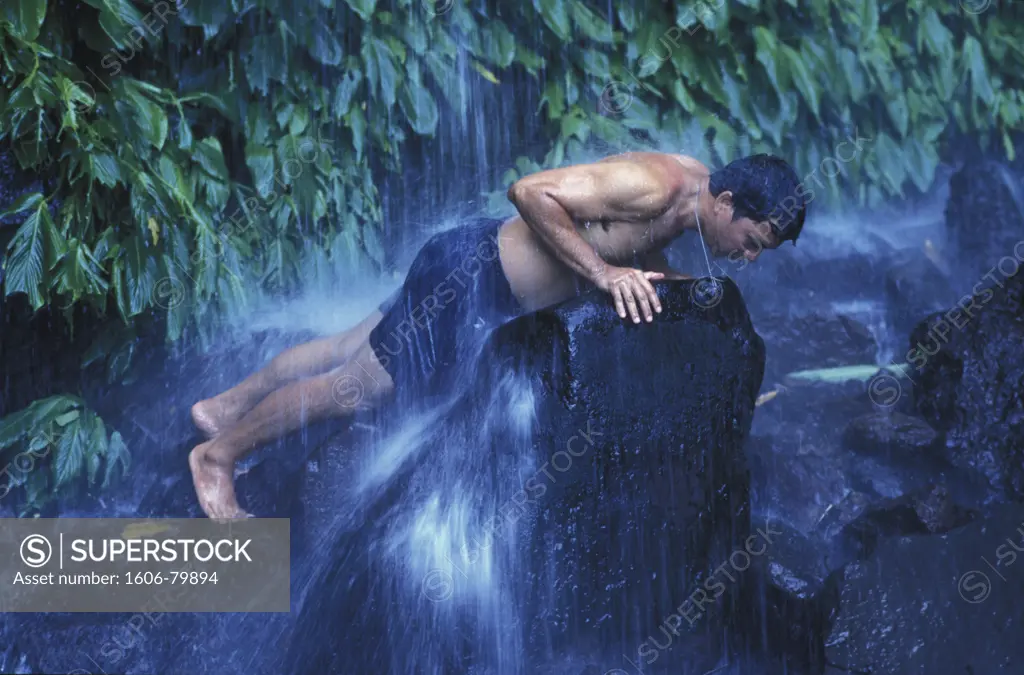 Philippines, Luzon, Quezon, Filipino pilgrim bathing in Suplinan Tubig waterfall on Holy Mount Banahaw
