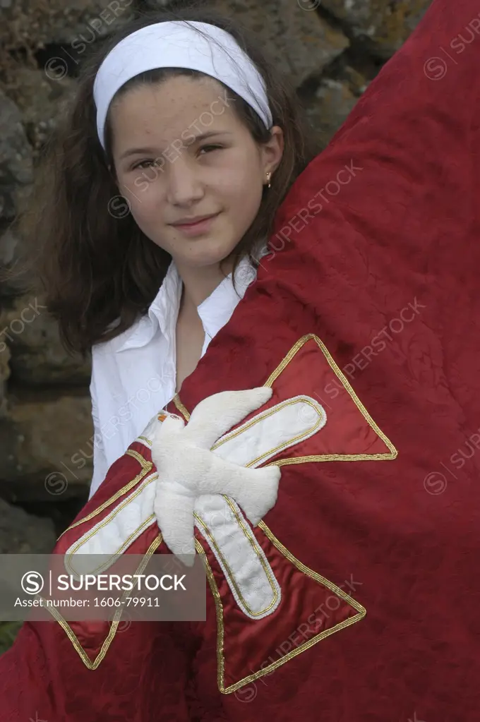 Portugal, Açores, Vila Nova, Girl carrying a banner in a catholic procession during Espiritu Santo Festival in Vila Novo, Terceira