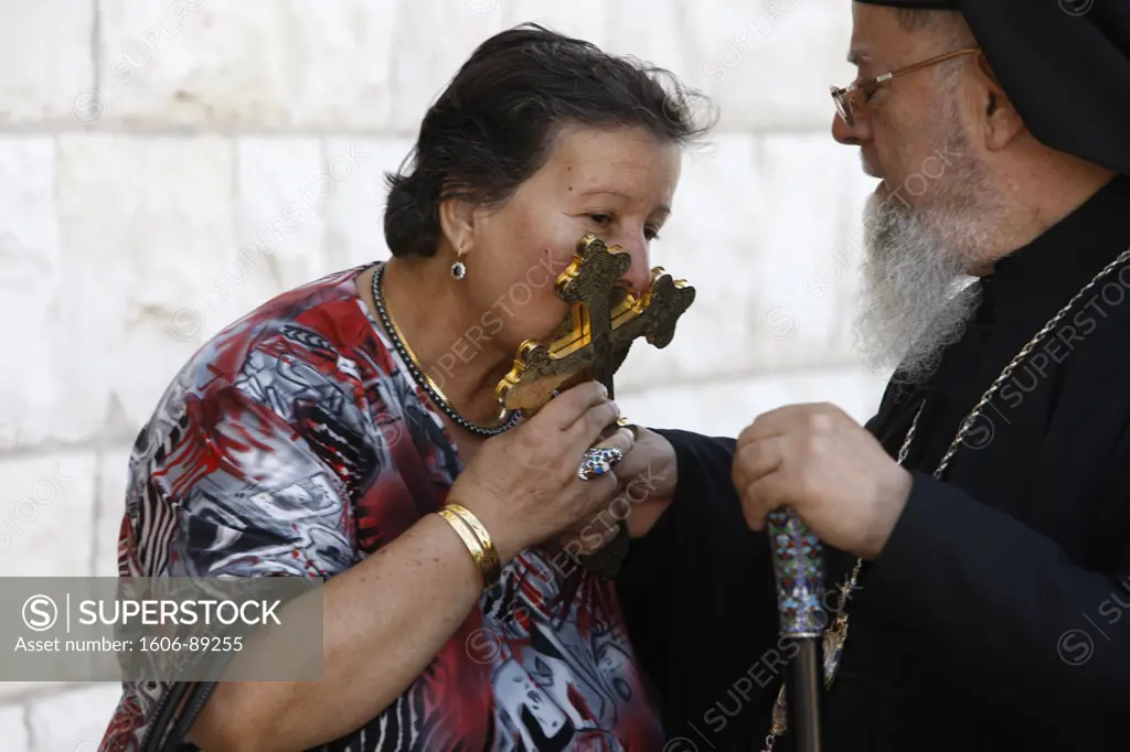 Israel, Haifa, Melkite (Greek-catholic) Palestinian woman kissing archbishop Elias Chacour's cross