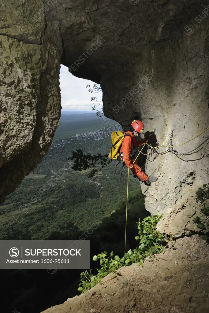 Speleology, caving, caver at the top of a pit in the middle of a cliff, Aven des Deux versants, Hrault