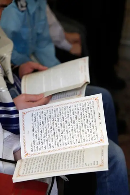 Purim celebration in a synagogue : reading the book of Esther . Montrouge. France.