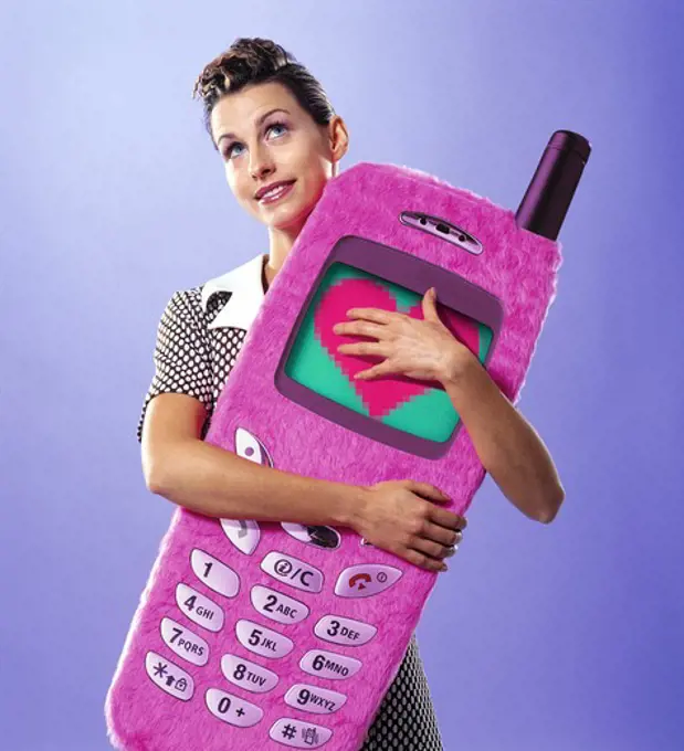 Smiling woman holding big cellphone in her arms
