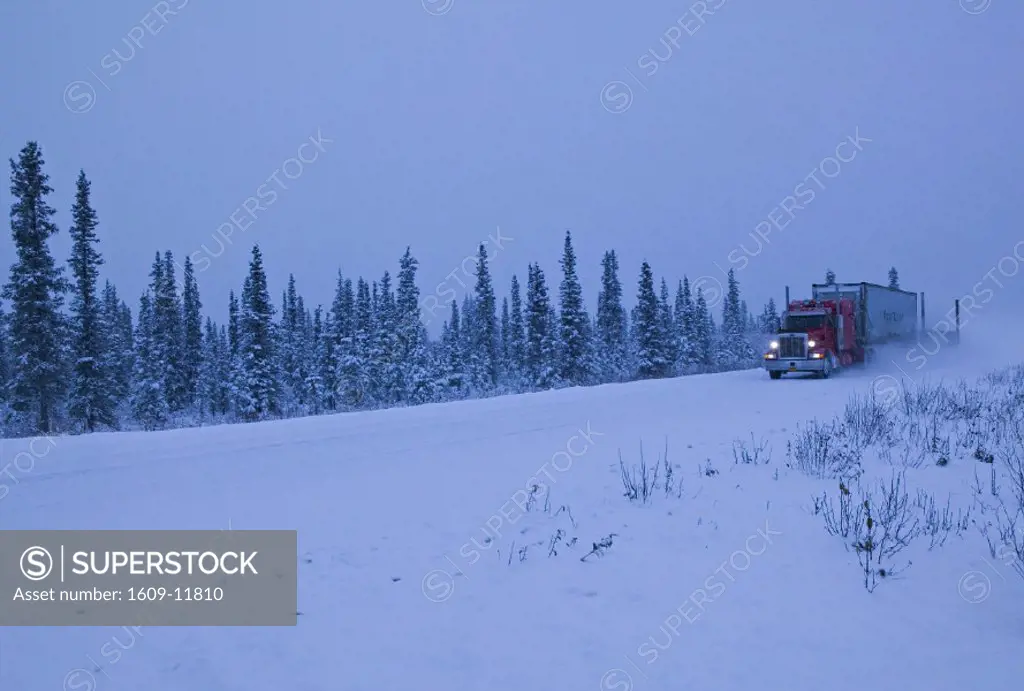 Truck on snowy road, Alaska, USA