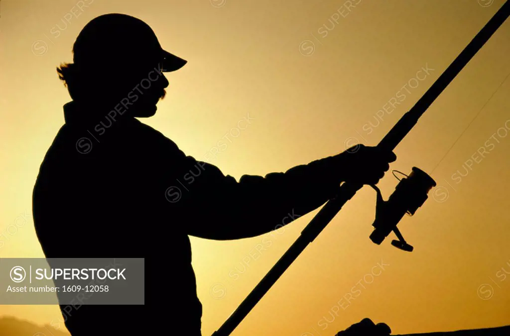 Sunset over Sea / Silhouette of Fisherman Casting Fishing Line, China -  SuperStock