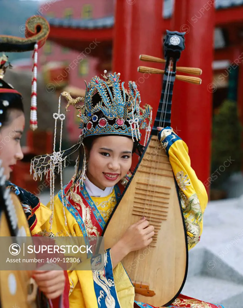 Women Dressed in Traditional Costume Playing Musical Instrument / Three Stringed Lute    , Beijing  , China