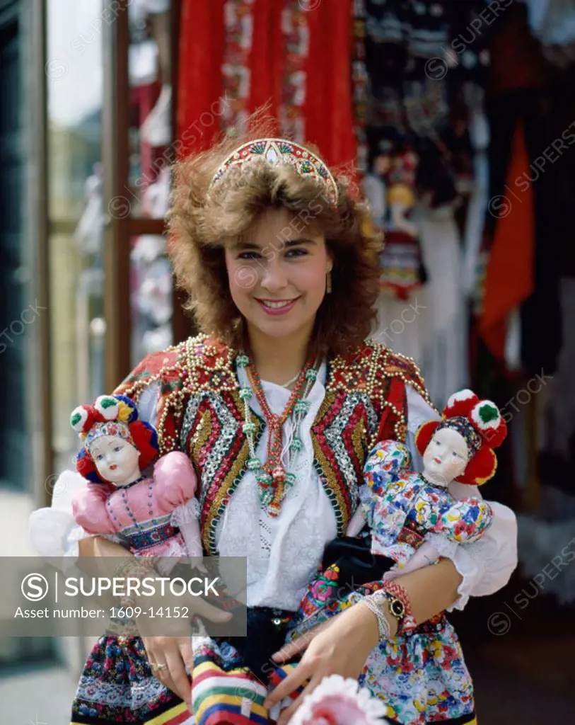 Girl Dressed in Traditional Hungarian Costume Selling Souvenir Dolls, Budapest, Hungary