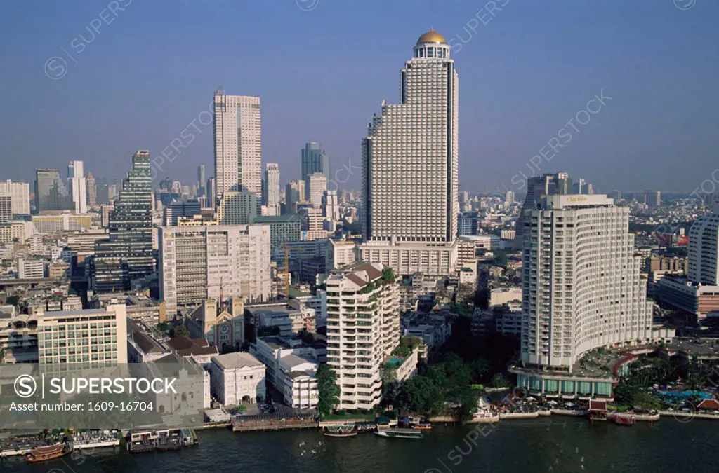Thailand, Bangkok, City Skyline with Chao Phraya River in Foreground