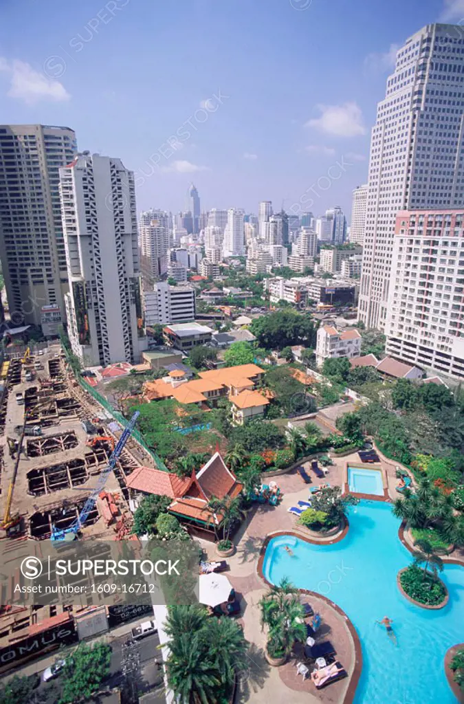Thailand, Bangkok, City Skyline with Swimming Pool and Construction Site in Foreground