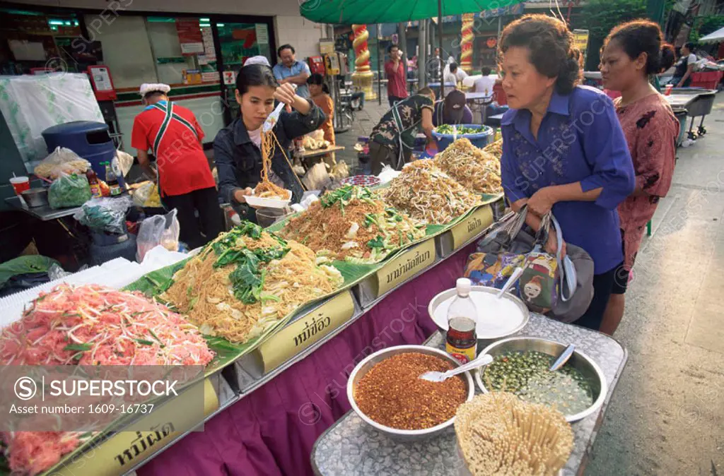 Thailand, Bangkok, Women Buying Noodles from Street Food Stall