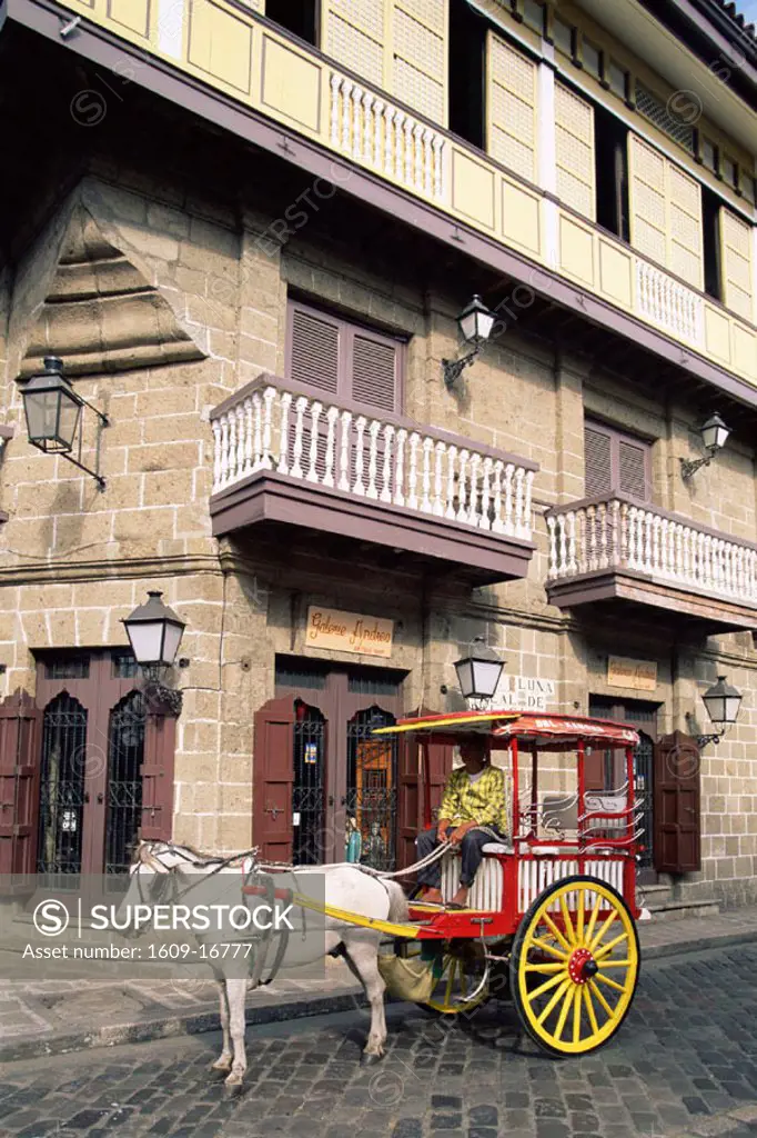 Philippines, Manila, Calesa or Horse-drawn Carriage and Spanish Colonial Building in the Intramuros Historical District