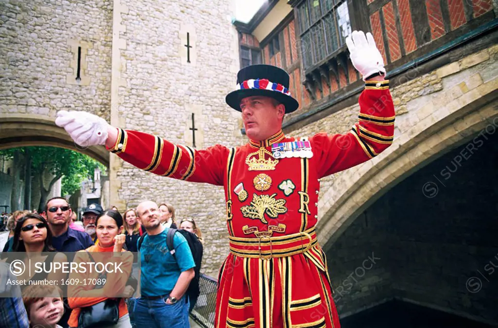 England, London, Tower of London, Beefeater in State Dress giving Guided Tour to Tourists