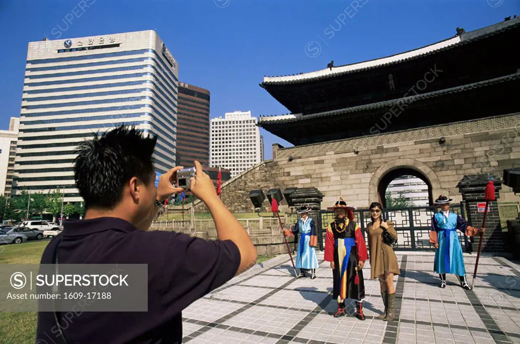 Korea, Seoul, Sungnyemun, South Gate, Asian Tourist Couple Taking Photos of Ceremonial Guards in Front of Sungnyemun Gate