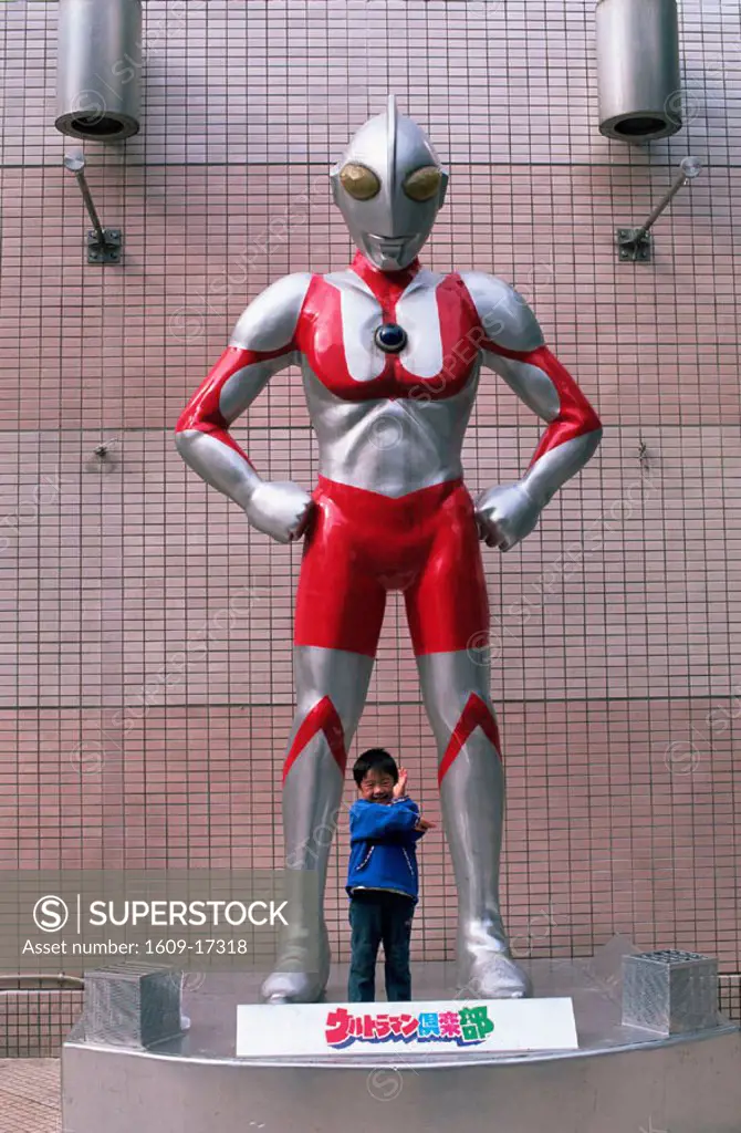 Japan, Honshu, Tokyo, Ultraman Statue and Young Child in Asakusa