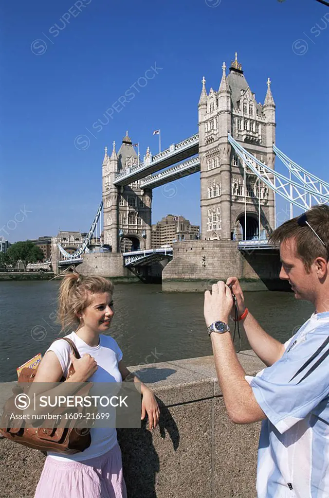 England,London,Young Tourist Couple taking Photoes with Digital Camera in front of Tower Bridge