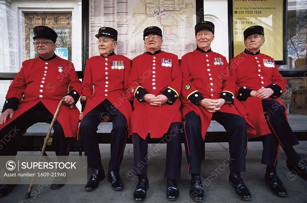 England,London,Chelsea Pensioners Sitting at Bus Stop