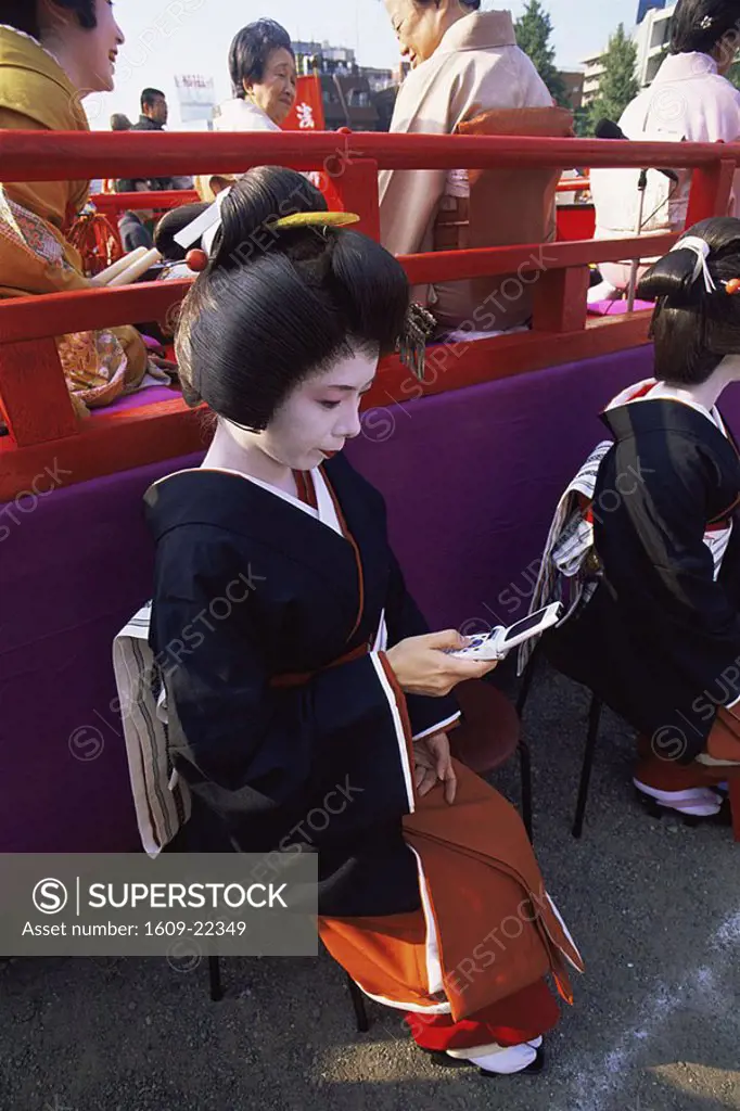 Japan, Tokyo, Geisha Using Mobile Phone, Jidai Matsuri Festival, Sensoji Temple Asakusa