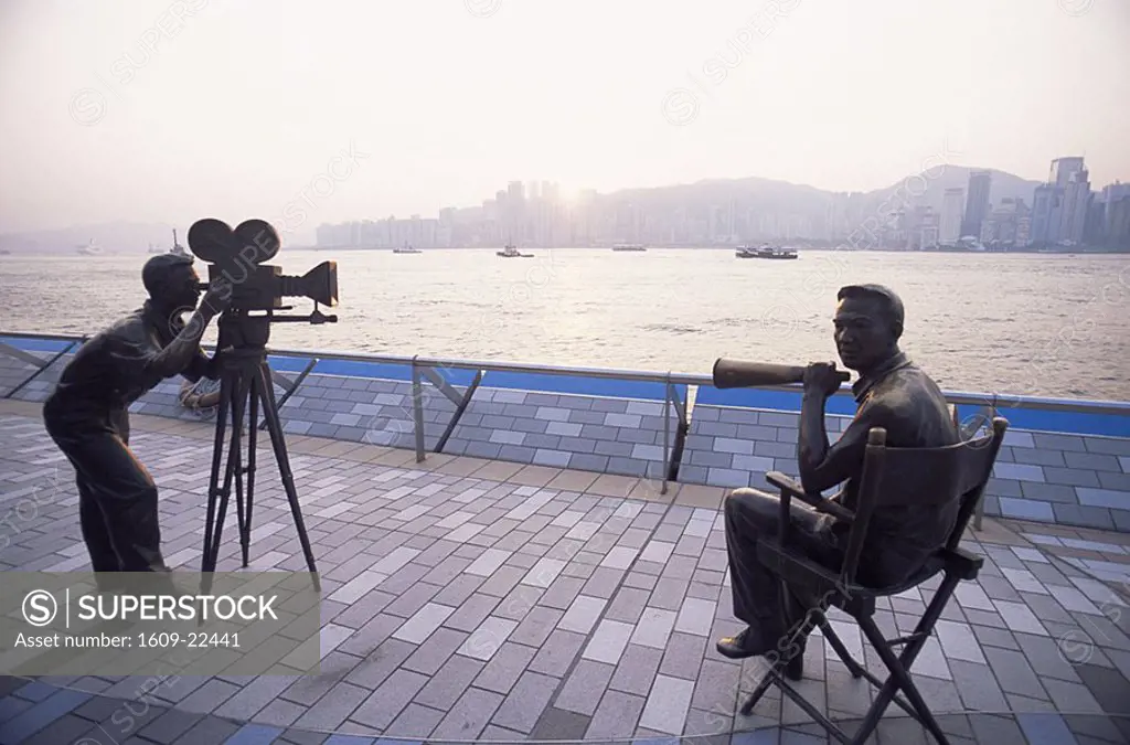 China, Hong Kong, Kowloon, Tsim Sha Tsui, Avenue of the Stars, Cameraman and Director Statues with Victoria Harbour in the Background