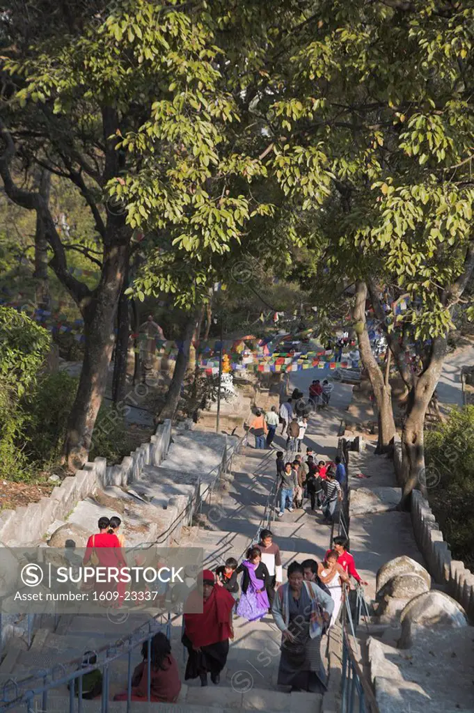 Nepal, Kathmandu, Swayambunath Stupa Monkey Temple Pilgrims climb steps up to the stupa