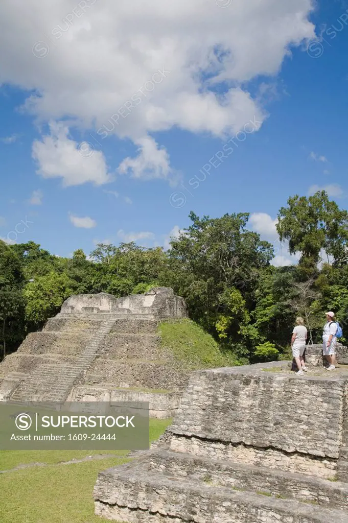 Belize, Caracol ruins, Plaza A, Ladies standing on Structure A6 _ Temple of the Wooden Lintel