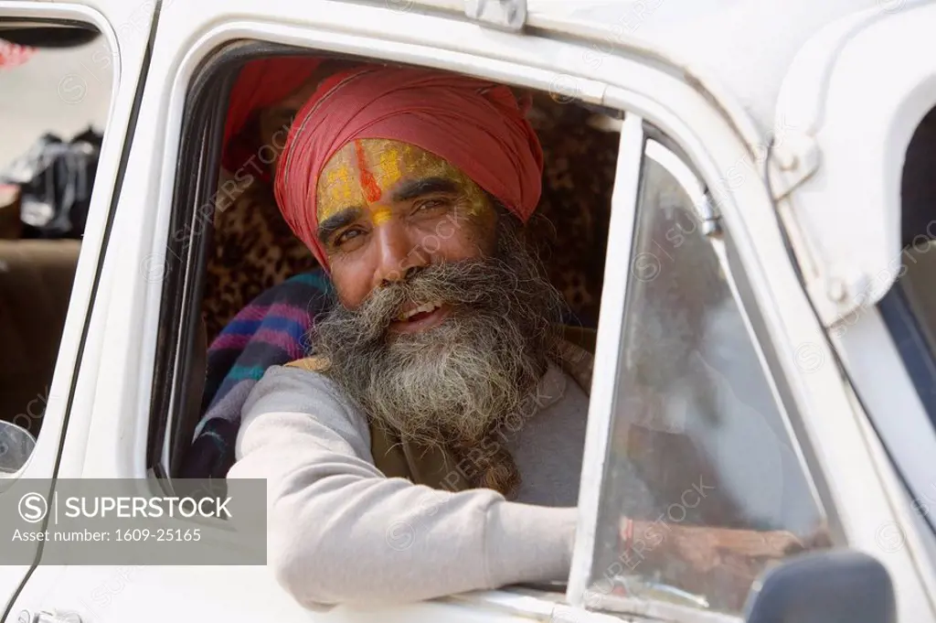 Holy Indian man driving car, Allahabad, Uttar Pradesh, India