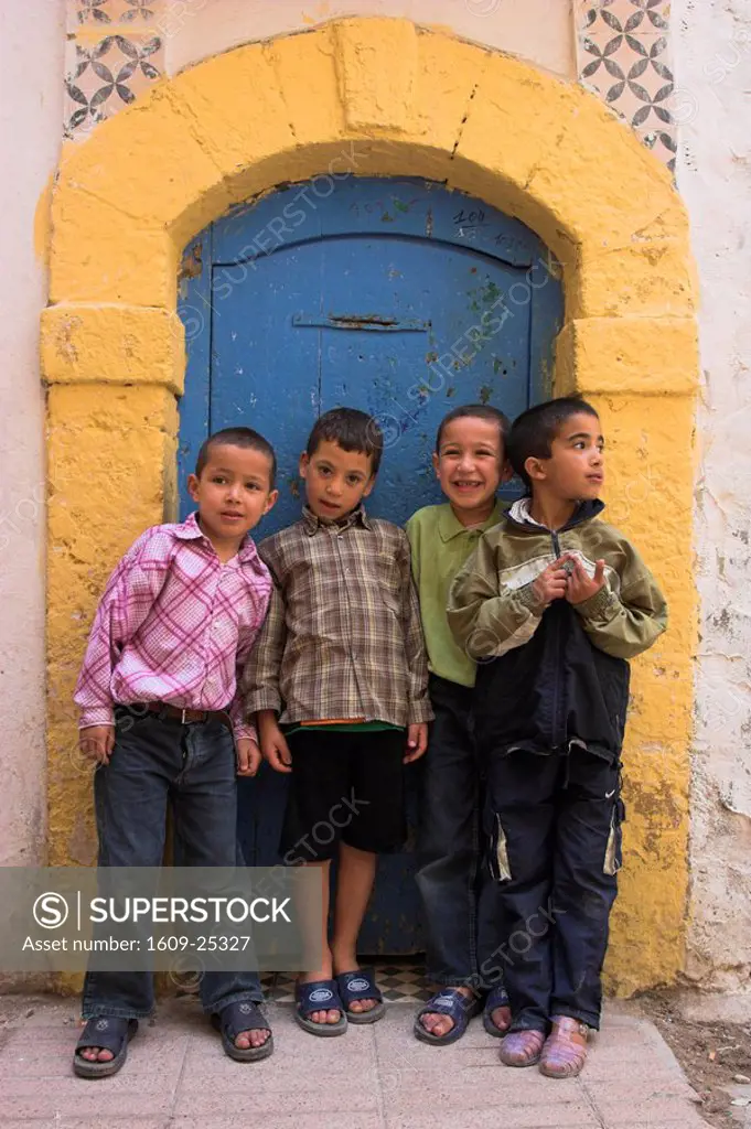 Morocco, Essaouira, Medina, Boys infront of blue and yellow door