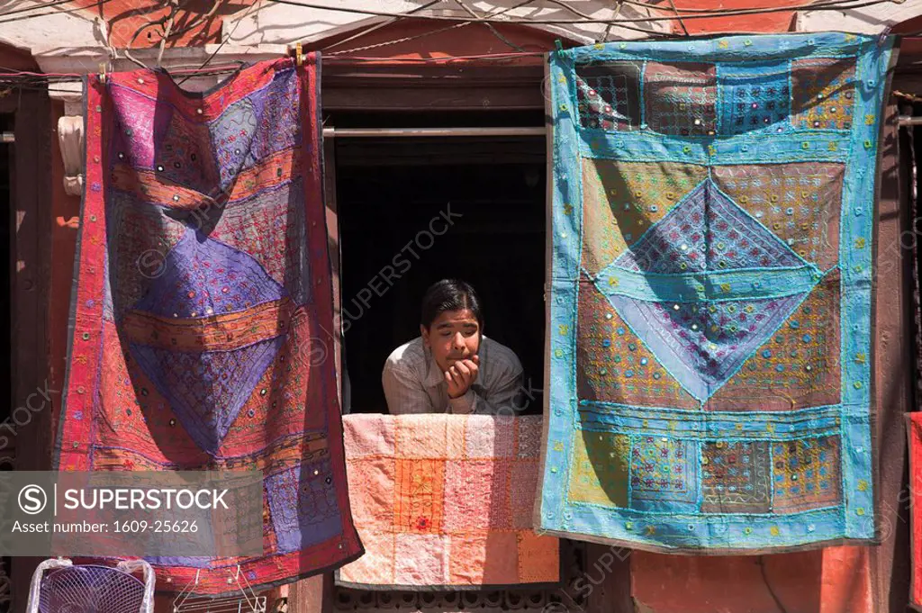 Nepal, Kathmandu, Man peers out of window of souviner shop