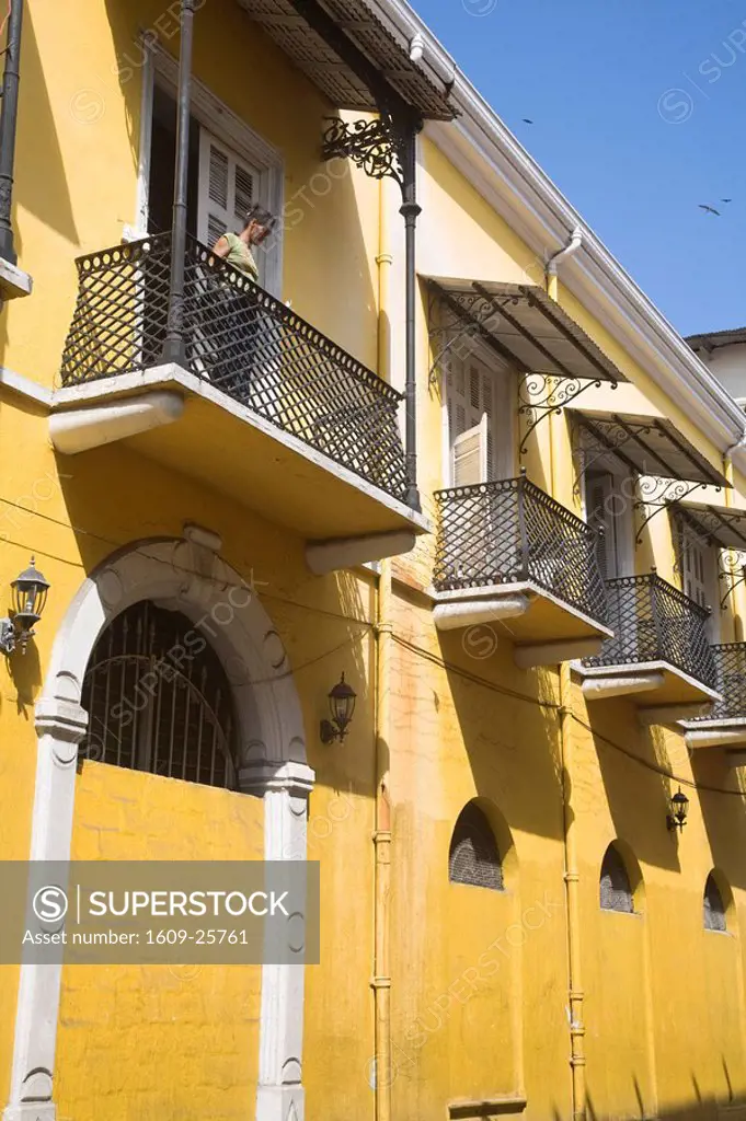 Panama, Panama City, Woman standing on balcony in Casco Viejo San Felipe