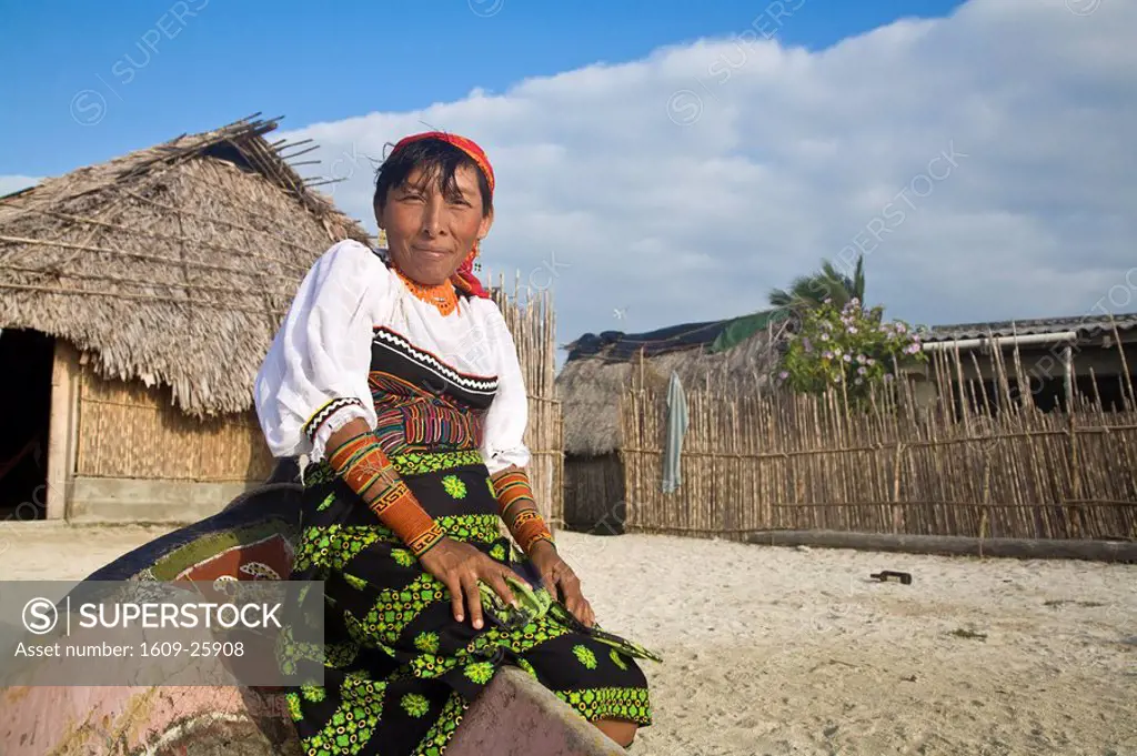 Panama, Comarca de Kuna Yala, San Blas Islands, Wichub_Wala Island, Kuna woman sitting on edge of canoe